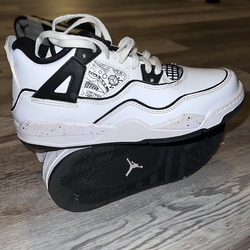 Black and white grade-school Jordan’s size 2.5